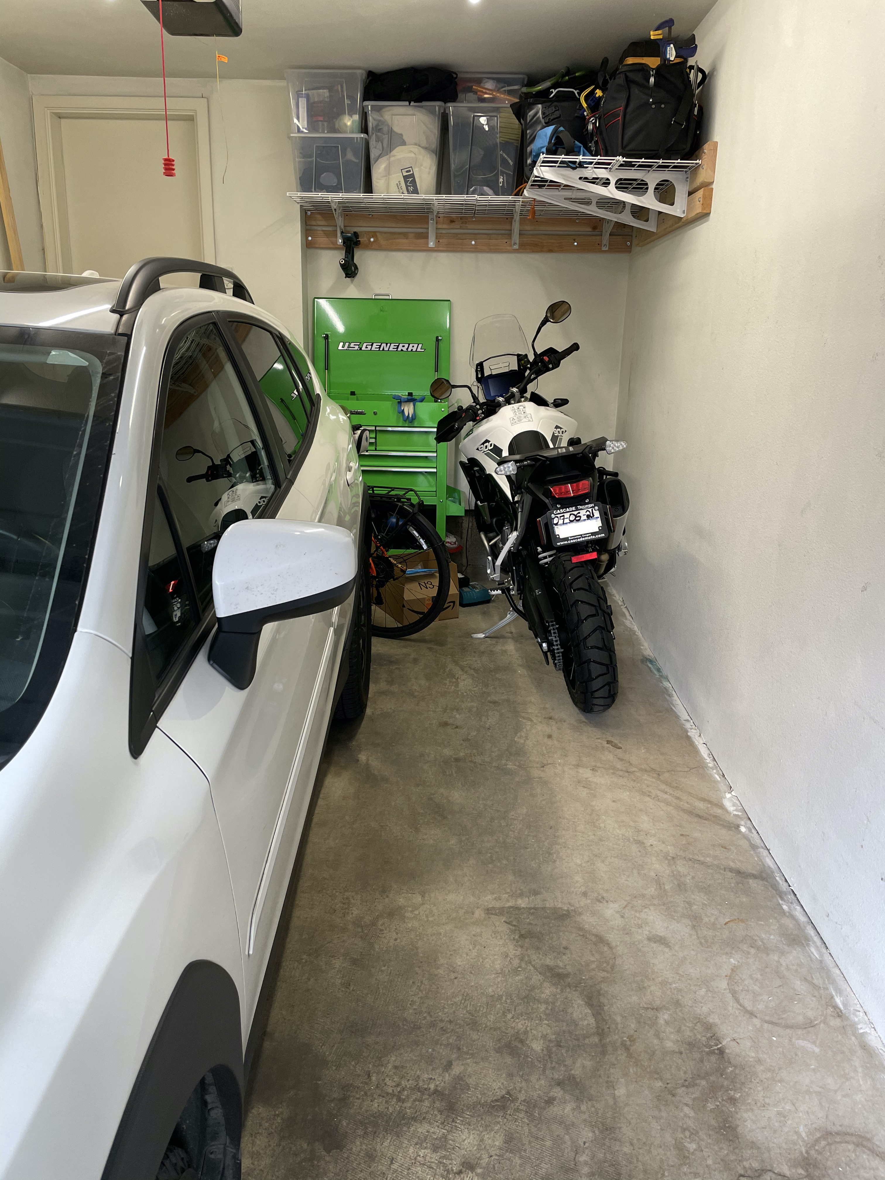 Motorcycle nestled into single car garage